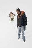 Boy Following Dads Footprints In The Snow Photo (1816691)