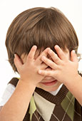 Studio Portrait Of Young Boy Covering Eyes Photo (mon187015)