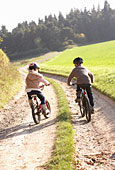 Two young children ride bicycles in park Photo (mon223145)