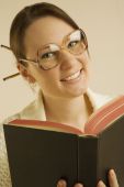 Woman Smiling And Reading Book Photo (1804894)