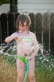 Girl playing outside with water on the summer Photo (4165670)