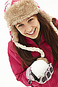 Teenage Girl Holding Snowball Wearing Fur Hat Photo (MON290040)